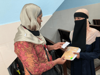 A Rohingya woman volunteer talks to a patient at Klinik Mewah 6 in Butterworth, Penang State, Malaysia.