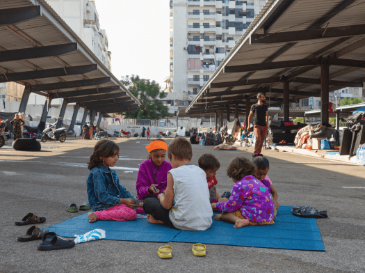 Syrian refugee children in a parking lot in Lebanon.