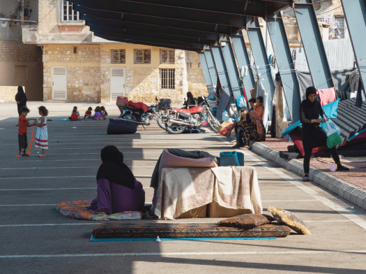 Displaced people living in a parking lot in Lebanon.