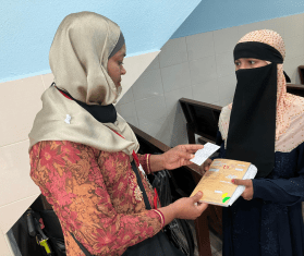 A Rohingya woman volunteer talks to a patient at Klinik Mewah 6 in Butterworth, Penang State, Malaysia.