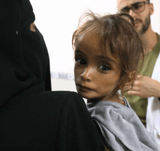 A young Palestinian girl is held at an MSF facility in Gaza.